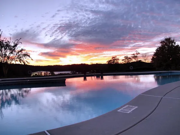 a bedroom with a bed and a flat tv screen on a dresser