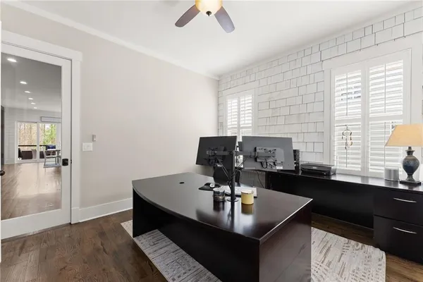 a bathroom with a sink a toilet a mirror and shower