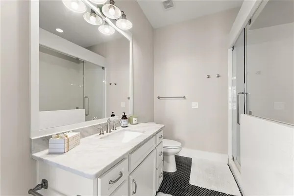 a bathroom with a sink and mirror with toilet