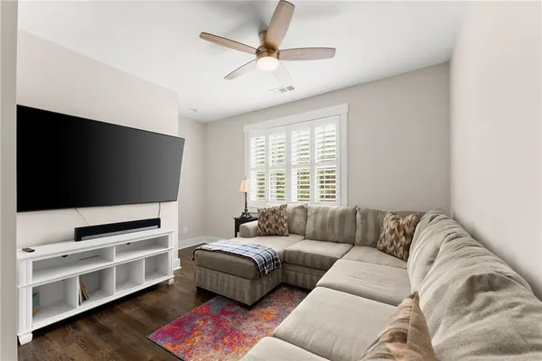 a spacious bedroom with a bed and a chandelier