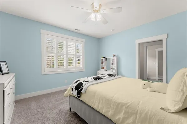 a bedroom with a bed and a painting on the wall