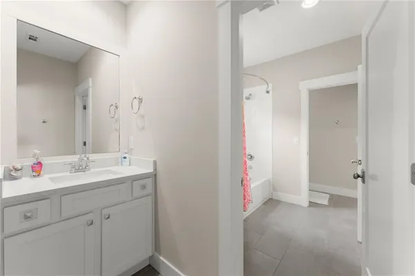 a bathroom with a granite countertop sink mirror and double