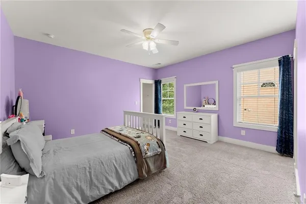 a spacious bedroom with a bed and a chandelier