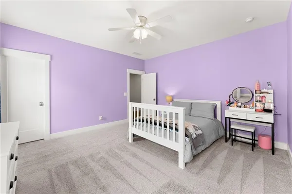 a bedroom with a bed and a ceiling fan