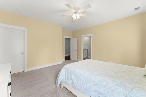 a kitchen with stainless steel appliances kitchen island granite countertop a wooden floor and white cabinets