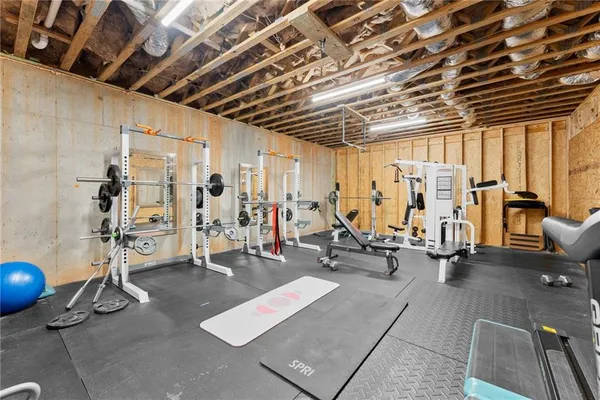 a view of a patio with table and chairs with wooden floor and fence