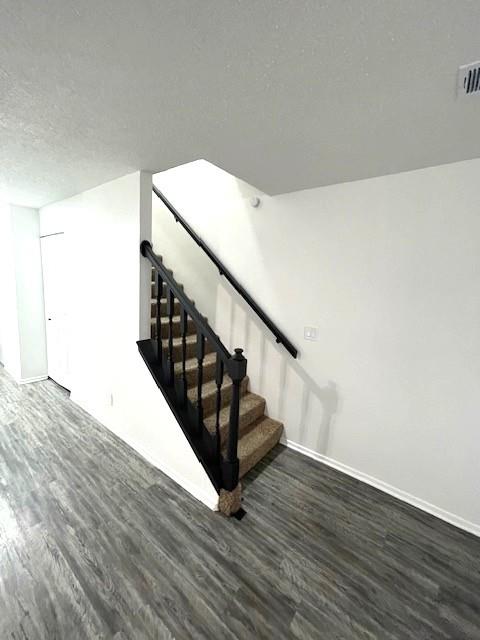 708 West Collins Street Denton, TX 76201 - Photo 18 of 40 Staircase with a textured ceiling