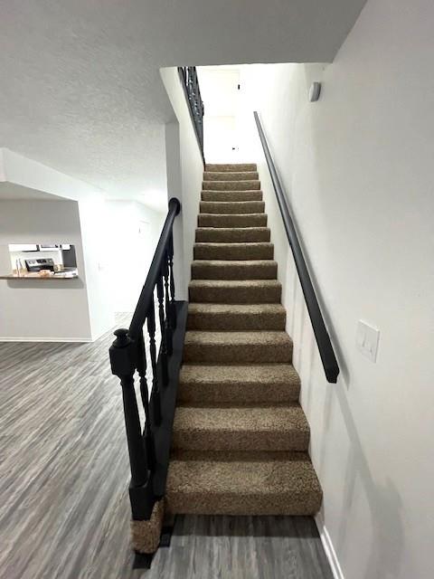 708 West Collins Street Denton, TX 76201 - Photo 19 of 40 Staircase a textured ceiling