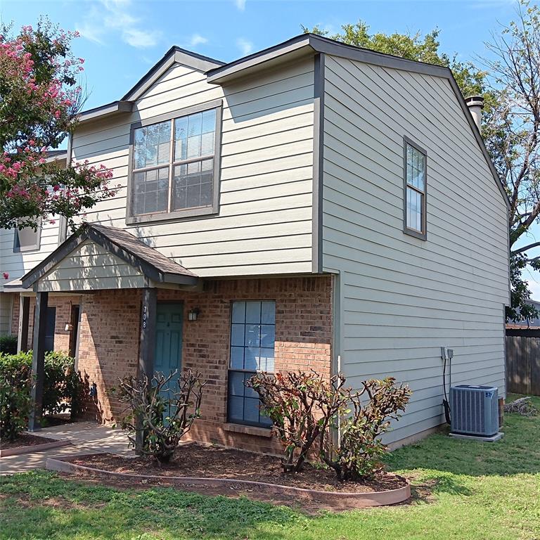 708 West Collins Street Denton, TX 76201 - Photo 2 of 40 View of front of house featuring brick siding, a front lawn, and a chimney