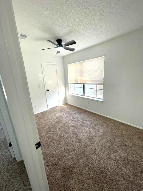 708 West Collins Street Denton, TX 76201 - Photo 21 of 40 3rd bedroom featuring a textured ceiling, wall-to-wall carpet, and a ceiling fan