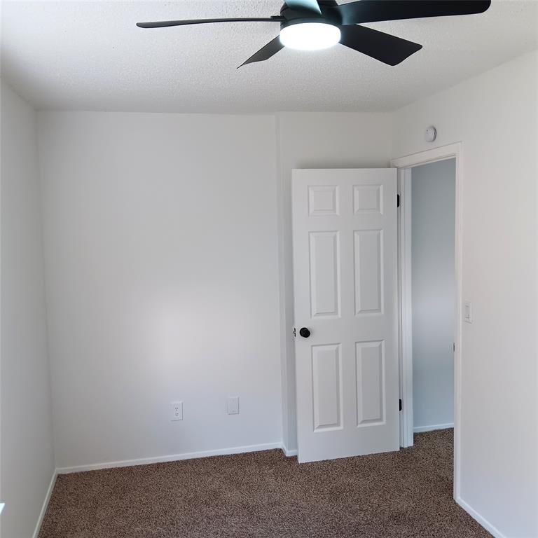 708 West Collins Street Denton, TX 76201 - Photo 22 of 40 3rd bedroom featuring wall-to-wall carpet floors, a textured ceiling, and a ceiling fan