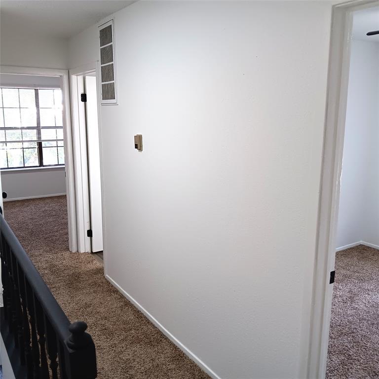708 West Collins Street Denton, TX 76201 - Photo 24 of 40 Hallway with dark carpet and baseboards