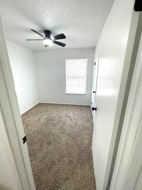 708 West Collins Street Denton, TX 76201 - Photo 25 of 40 2nd bedroom room with wall-to-wall carpet and a textured ceiling and ceiling fan