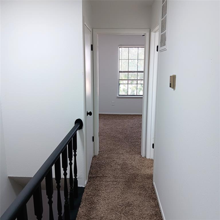 708 West Collins Street Denton, TX 76201 - Photo 27 of 40 Hall with carpet and an upstairs landing
