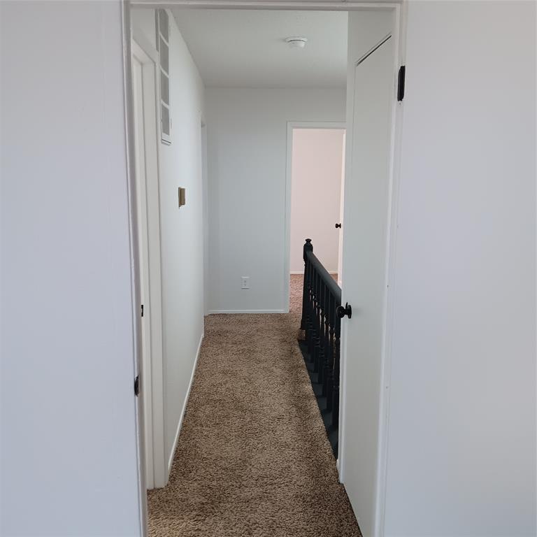 708 West Collins Street Denton, TX 76201 - Photo 34 of 40 Hallway featuring carpet floors and an upstairs landing