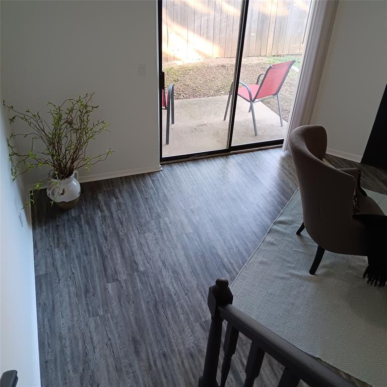 708 West Collins Street Denton, TX 76201 - Photo 36 of 40 Living room with light gray wood-pattern vinyl plank flooring and baseboards