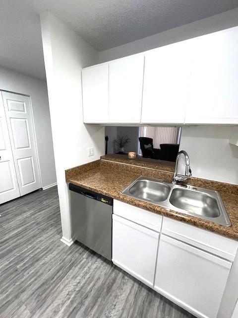 708 West Collins Street Denton, TX 76201 - Photo 10 of 40 Kitchen featuring stainless steel appliances, light gray wood-pattern vinyl plank flooring, white cabinets, and a textured ceiling