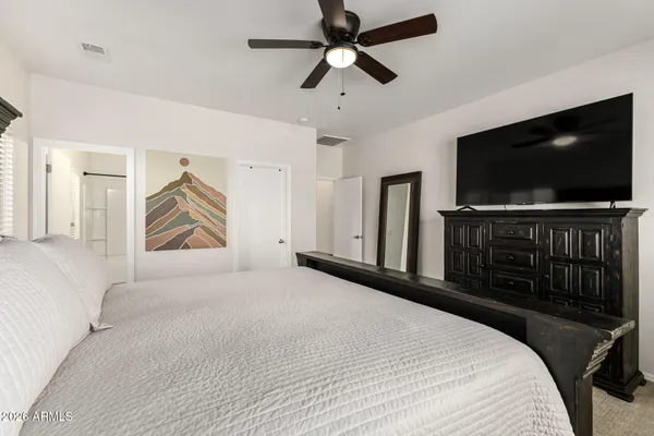 a bedroom with a bed and a flat screen tv