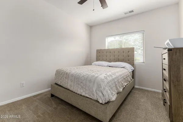 a bed sitting in a bedroom next to a window