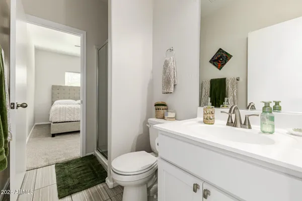 a en suite bathroom with a sink and a mirror