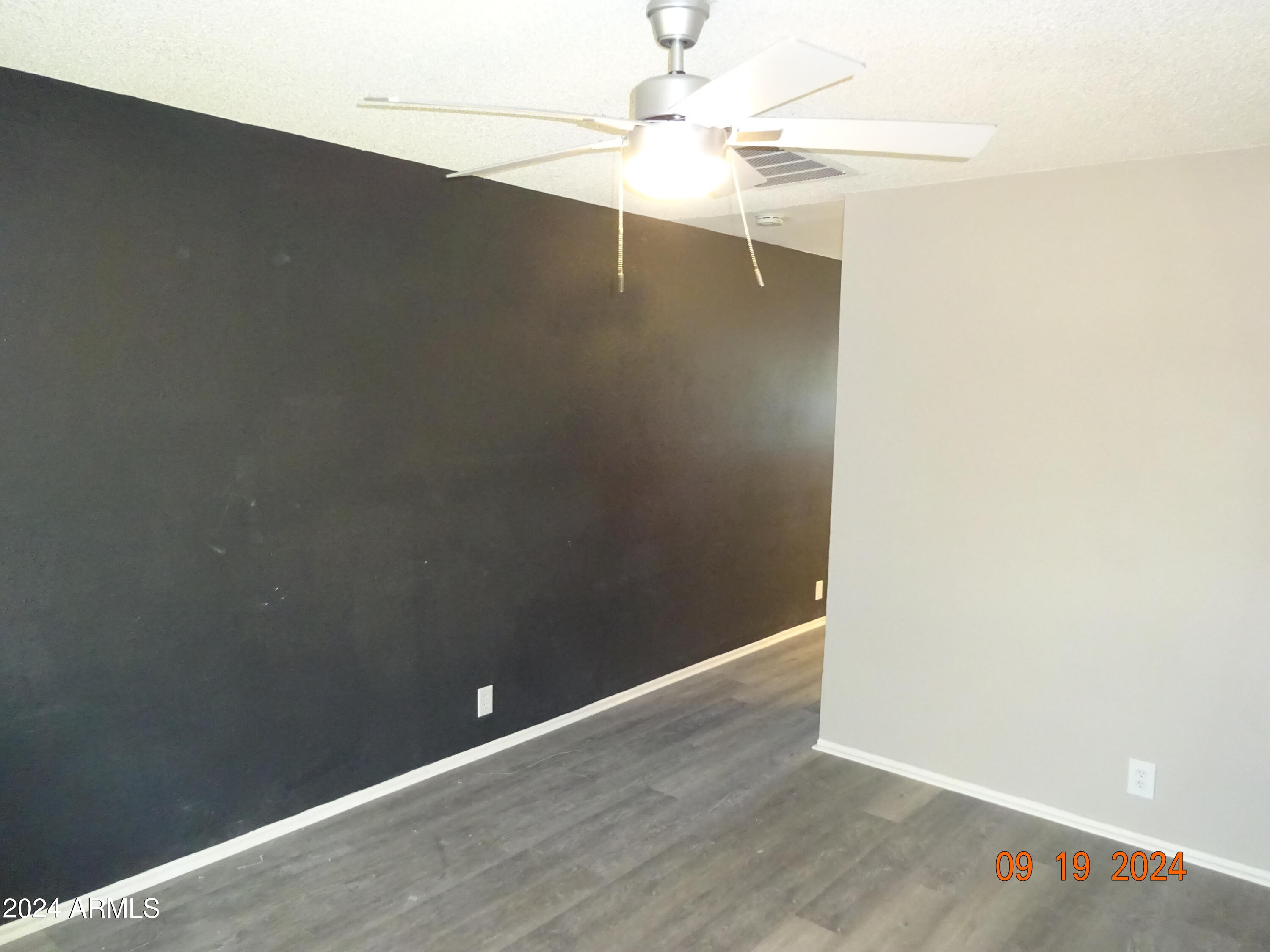 341 East Vogel Avenue, Unit 2 Phoenix, AZ 85020 - Photo 4 of 12 an empty room with a fan & a ceiling fan