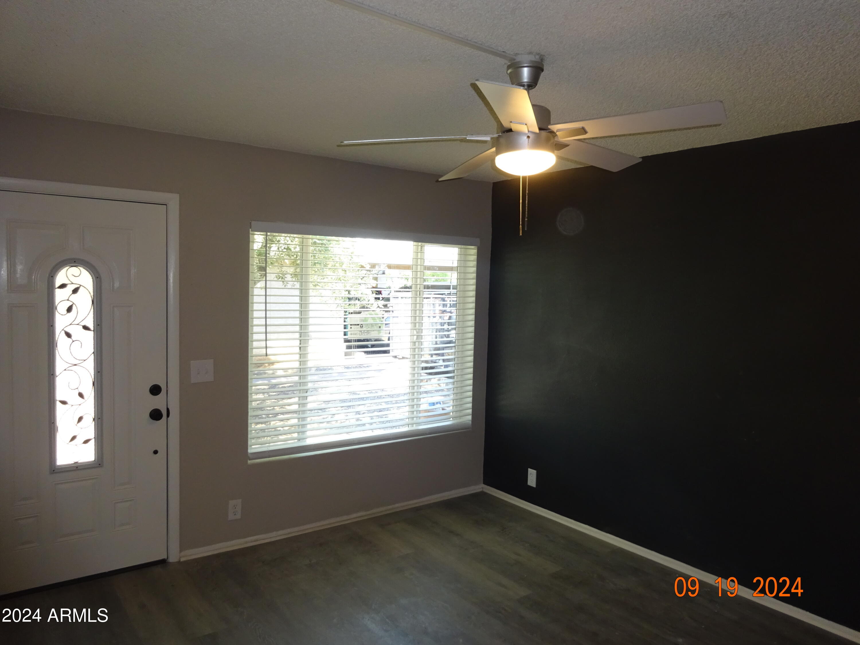 341 East Vogel Avenue, Unit 2 Phoenix, AZ 85020 - Photo 6 of 12 a view of an empty room with window and chandelier fan