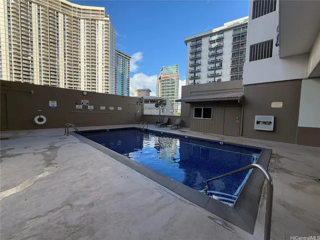 a living room with furniture floor to ceiling window and plants