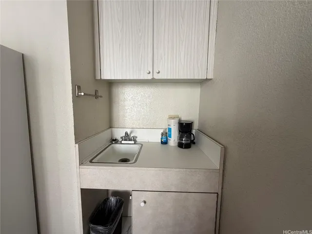 a kitchen with a sink and cabinets