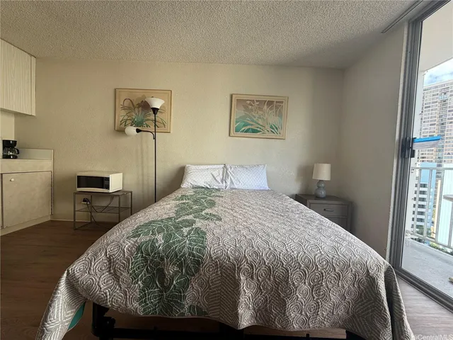 a bedroom with a bed and a table in it with window