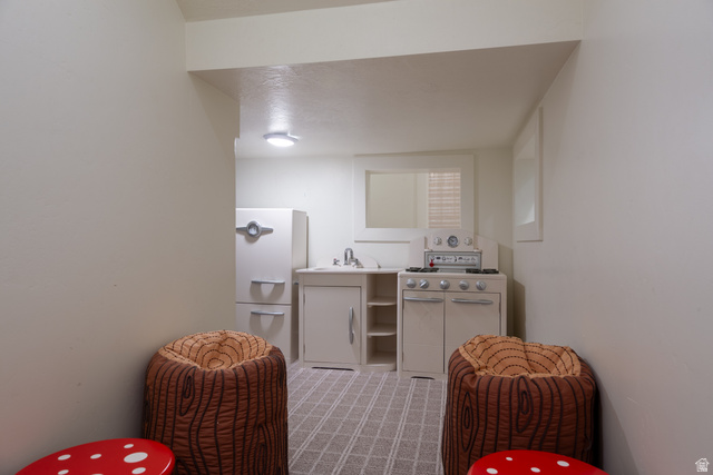630 East Center Street Alpine, UT 84004 - Photo 69 of 115 Built-in white cabinetry featuring a sink, range, and refrigerator