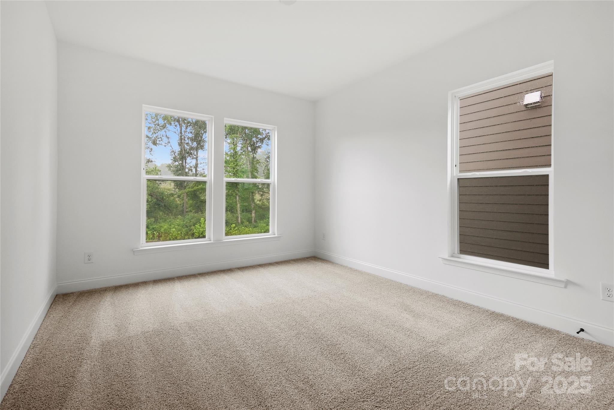 9373 Moss Plantation Avenue Northwest Concord, NC 28027 - Photo 16 of 27 an empty room with windows