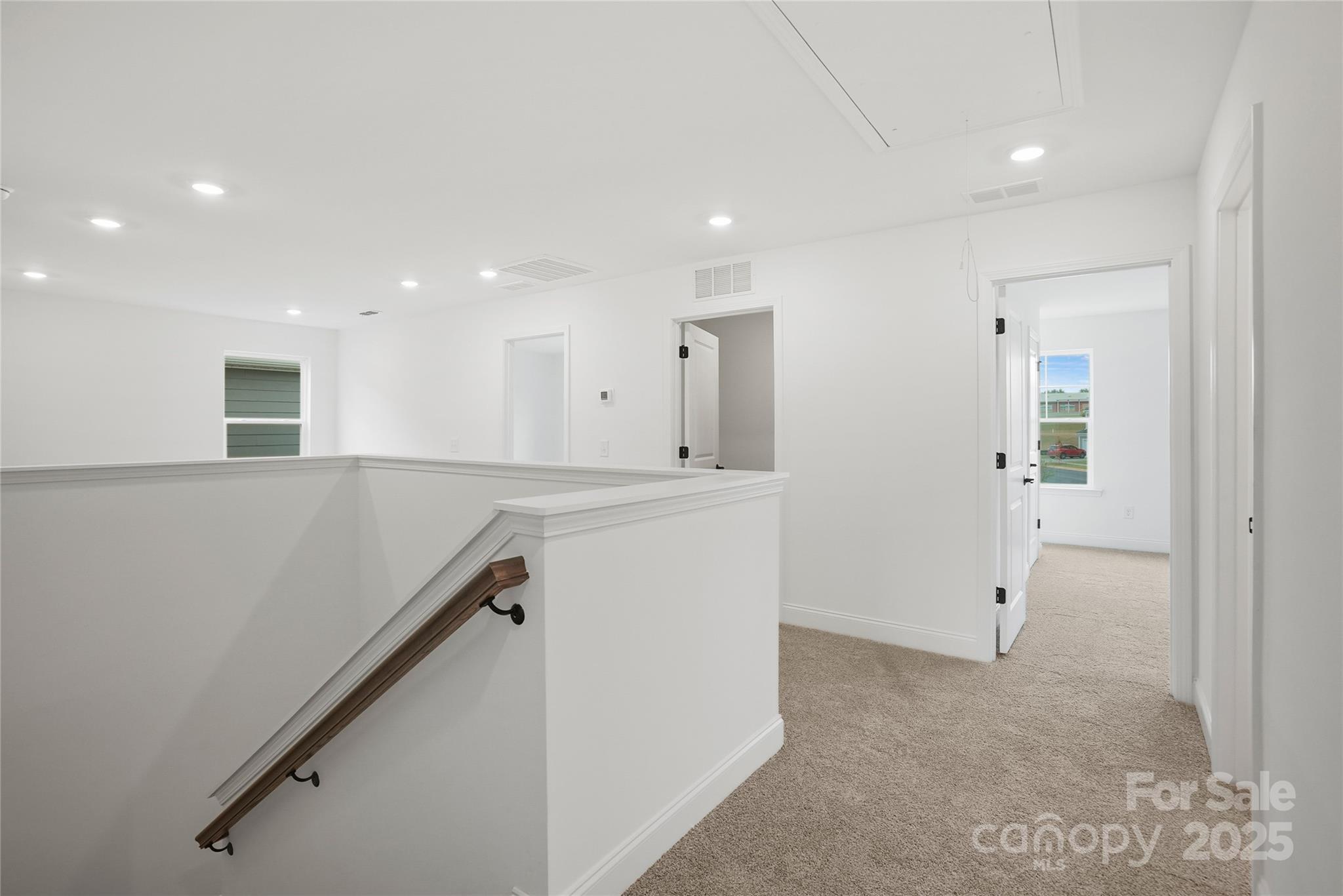 9373 Moss Plantation Avenue Northwest Concord, NC 28027 - Photo 18 of 27 a view of a hallway with wooden floor and staircase