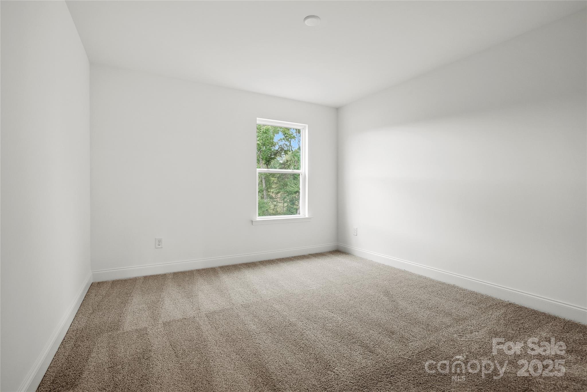 9373 Moss Plantation Avenue Northwest Concord, NC 28027 - Photo 22 of 27 an empty room with a window