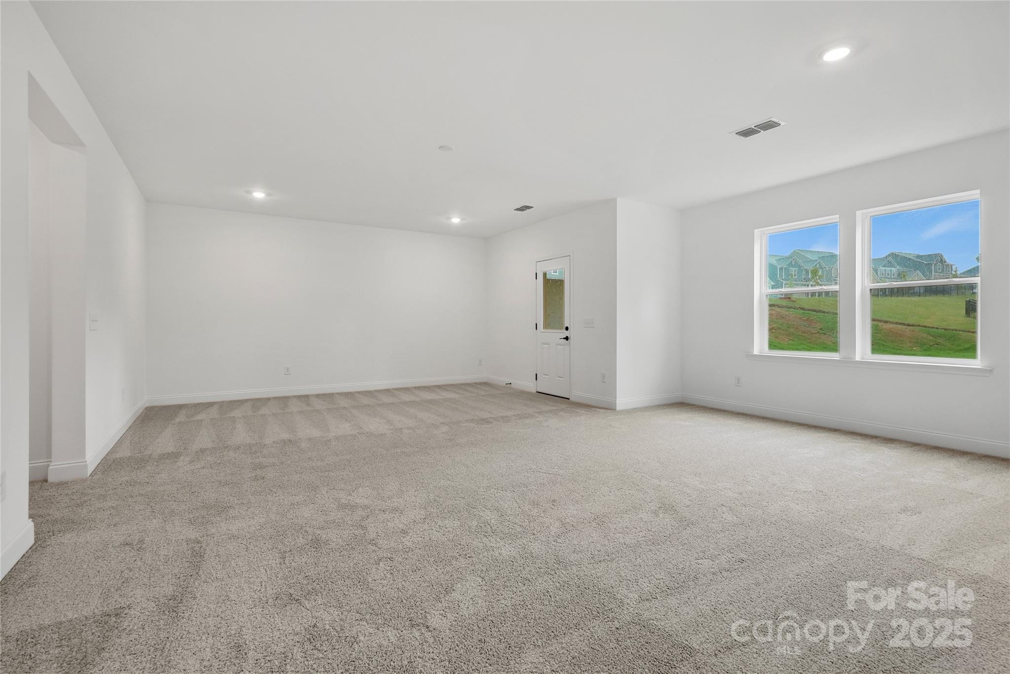 9373 Moss Plantation Avenue Northwest Concord, NC 28027 - Photo 23 of 27 an empty room with windows