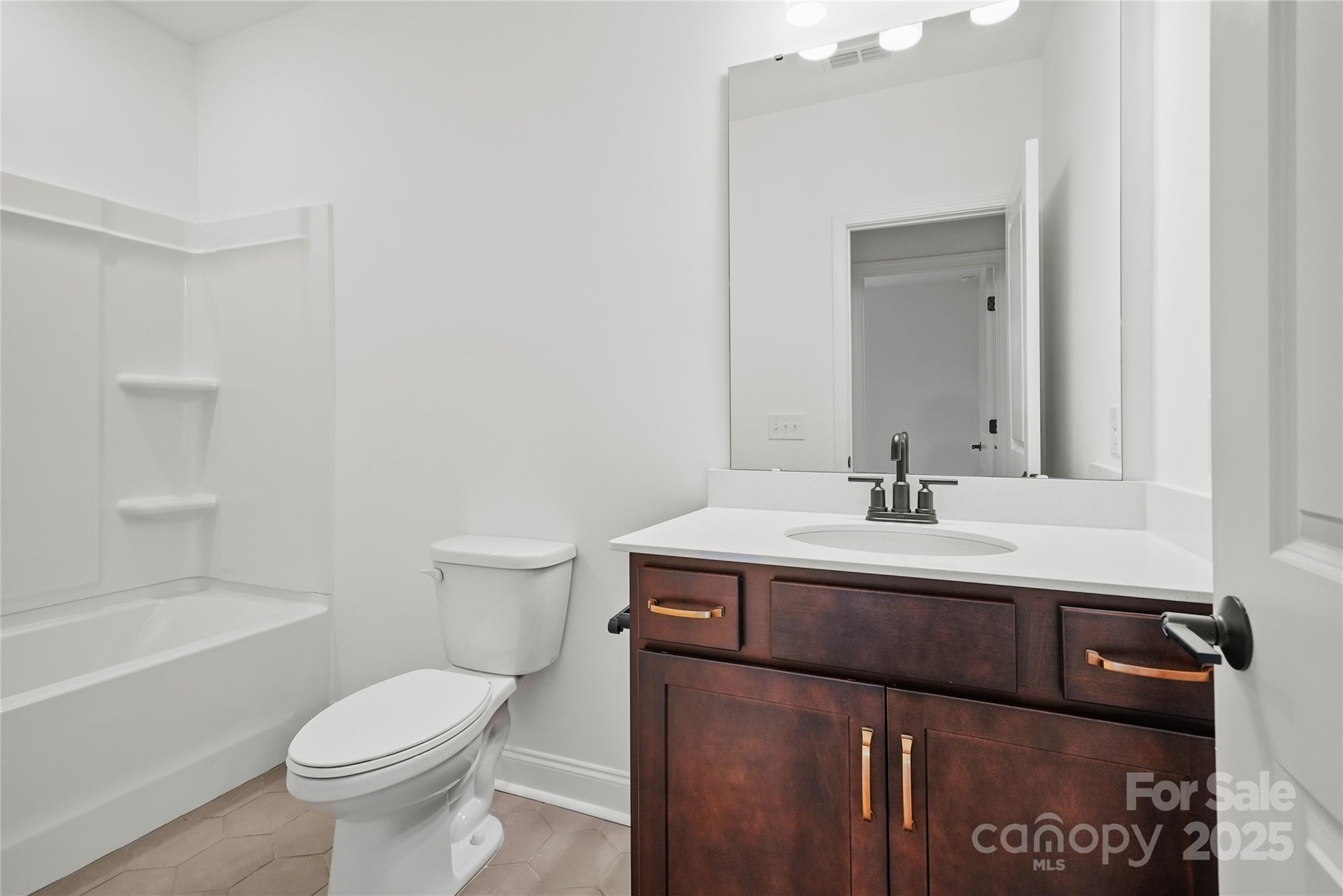 9373 Moss Plantation Avenue Northwest Concord, NC 28027 - Photo 26 of 27 a bathroom with a sink a toilet and shower