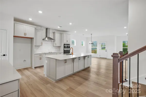 a kitchen with white cabinets appliances and sink