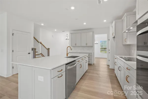 a kitchen with stainless steel appliances granite countertop a stove and a sink
