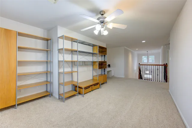 a view of an empty room with a ceiling fan
