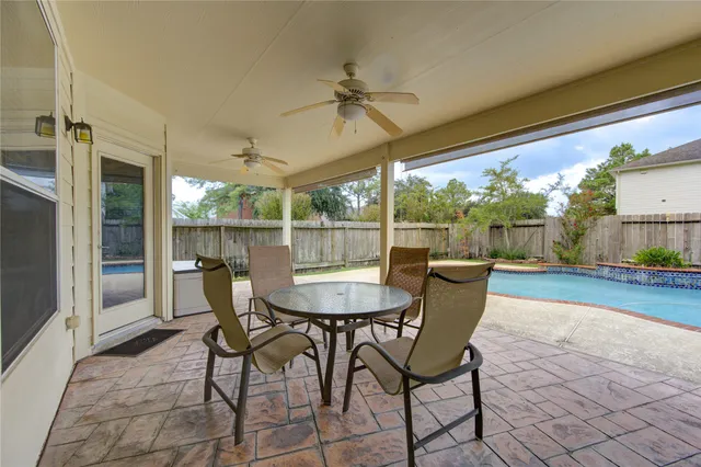 a dining room with furniture and a floor to ceiling window