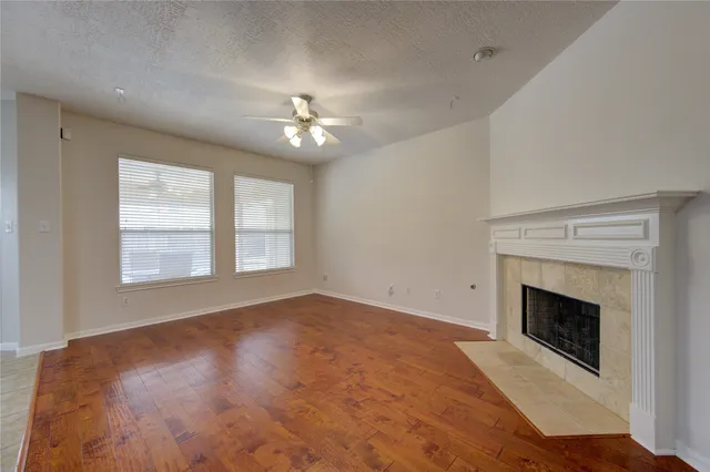 a view of empty room with a fireplace