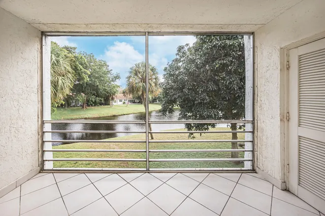 a view of empty room with staircase and a window