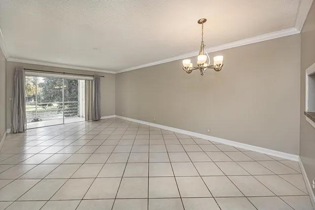 a view of a livingroom with an empty space and a window