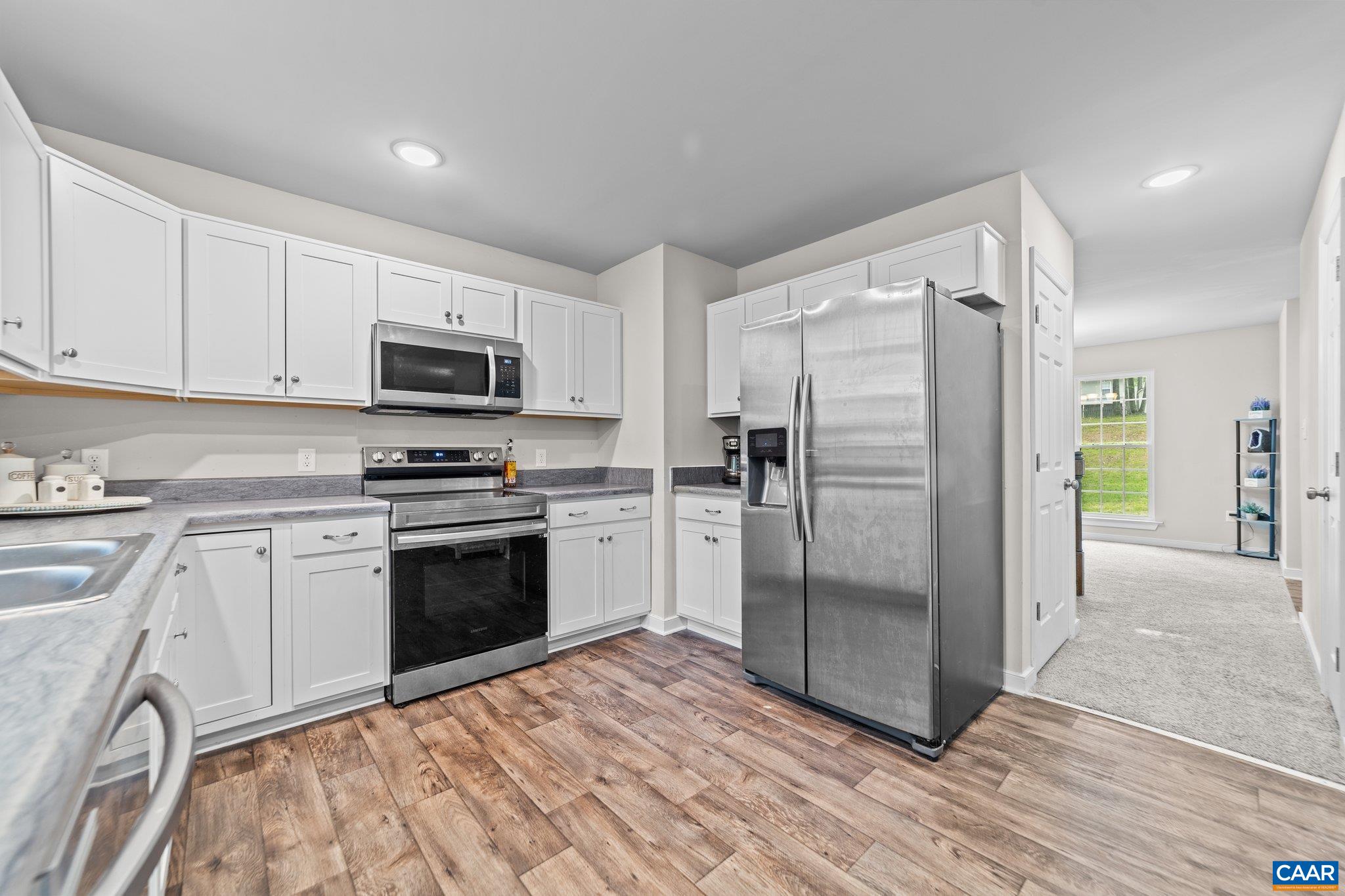 39 Amethyst Road Palmyra, VA 22963 - Photo 11 of 42 a kitchen with granite countertop a refrigerator stove and microwave