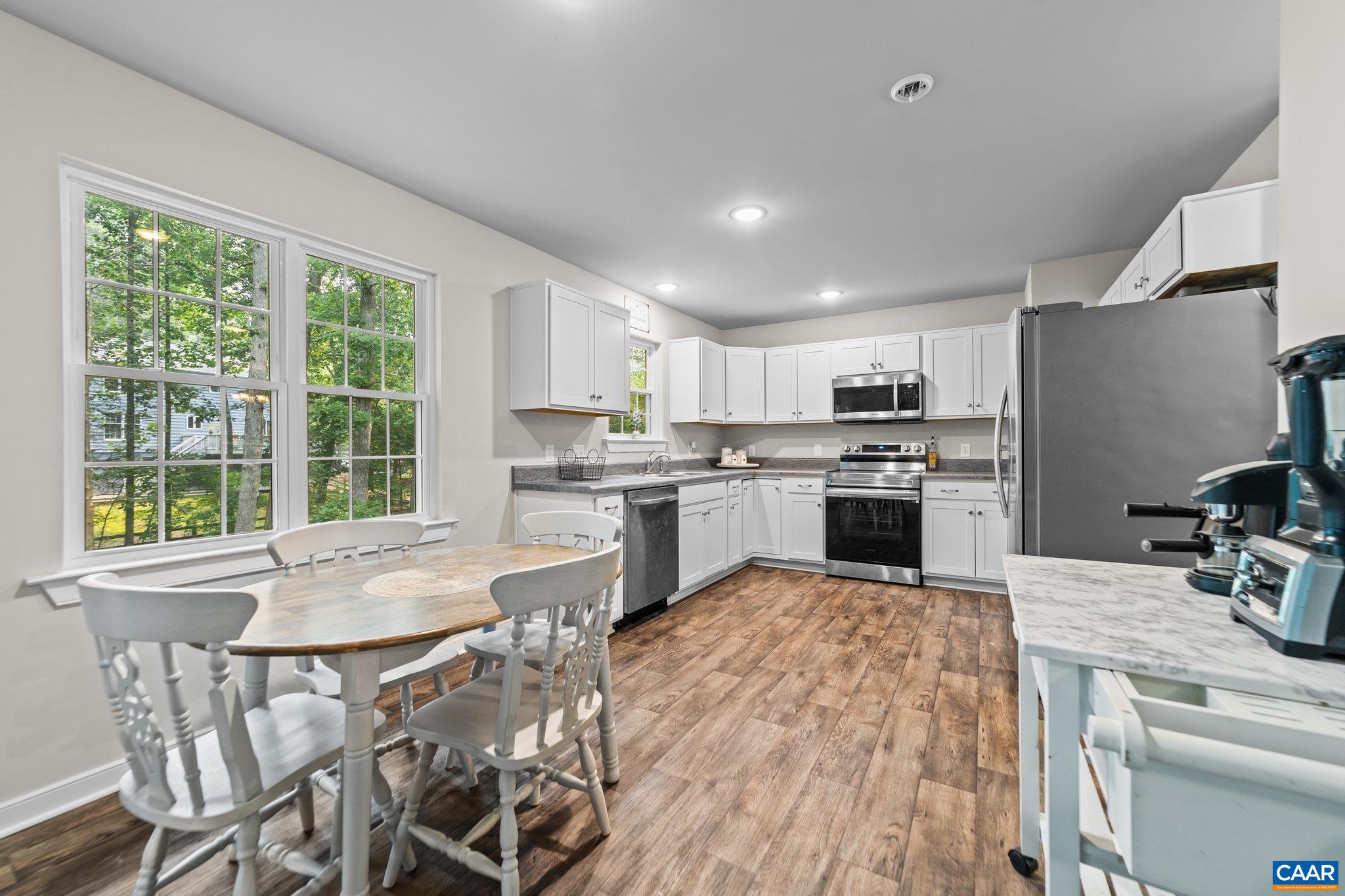39 Amethyst Road Palmyra, VA 22963 - Photo 8 of 42 a kitchen with a table chairs refrigerator and cabinets