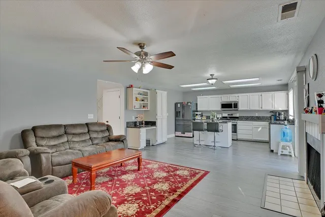 a living room with furniture and kitchen view