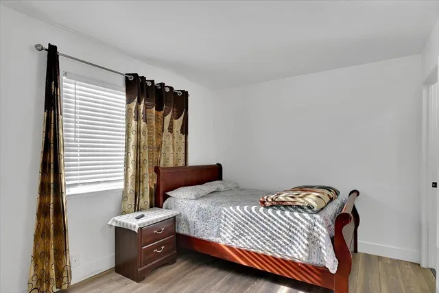 a bedroom with a bed and a window