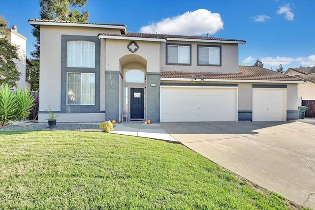 a front view of a house with a garden