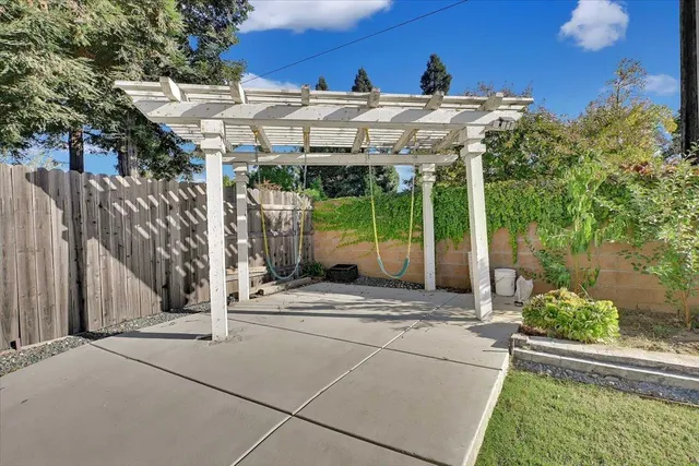 a view of a house with a yard and potted plants