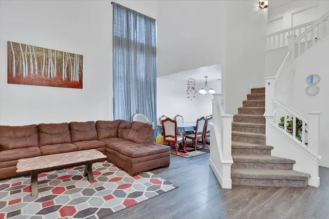 a living room with furniture and stairs