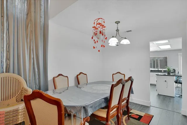 a view of a dining room with furniture and chandelier